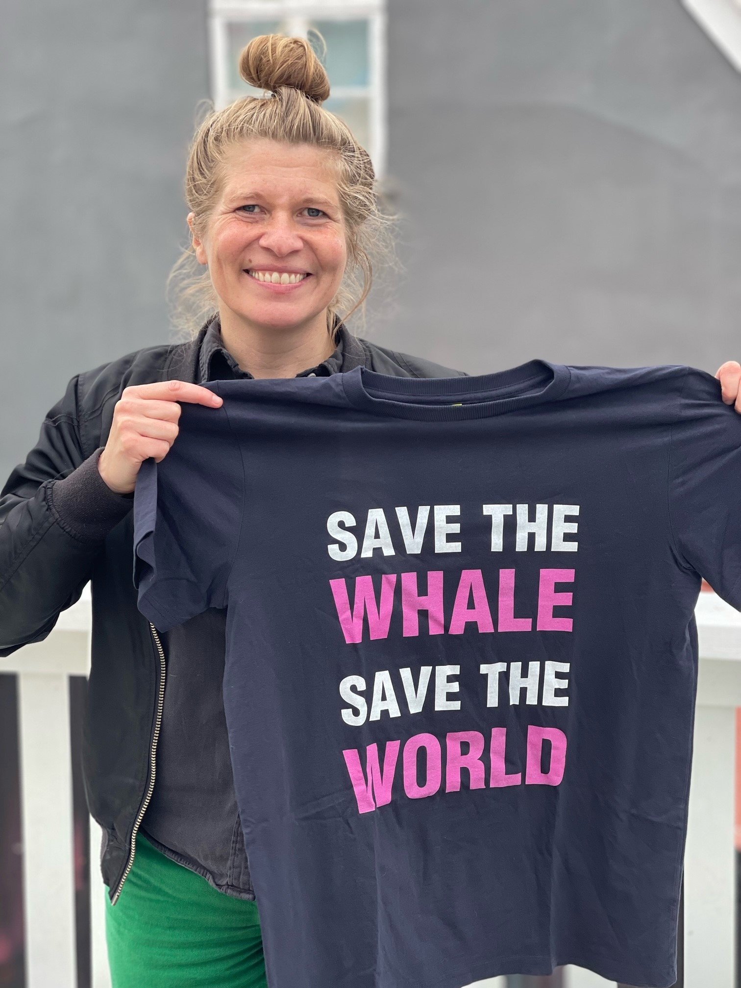 Kattrin Oddsdottir holding t-shirt saying Save the whale. Save the world.